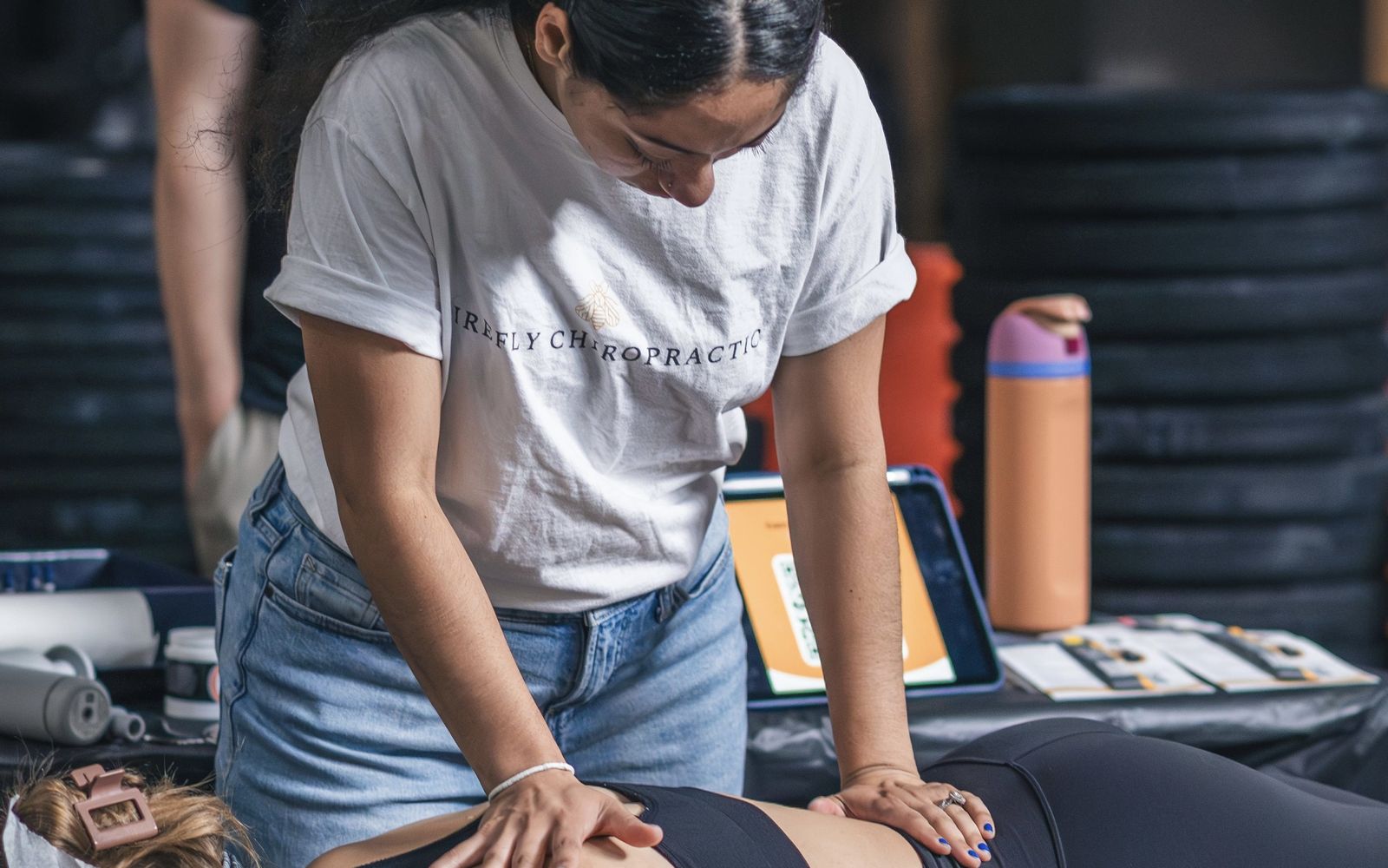 Dr. Stef Cruz-Kostrova treating a patient at Firefly Chiropractic in Wauwatosa