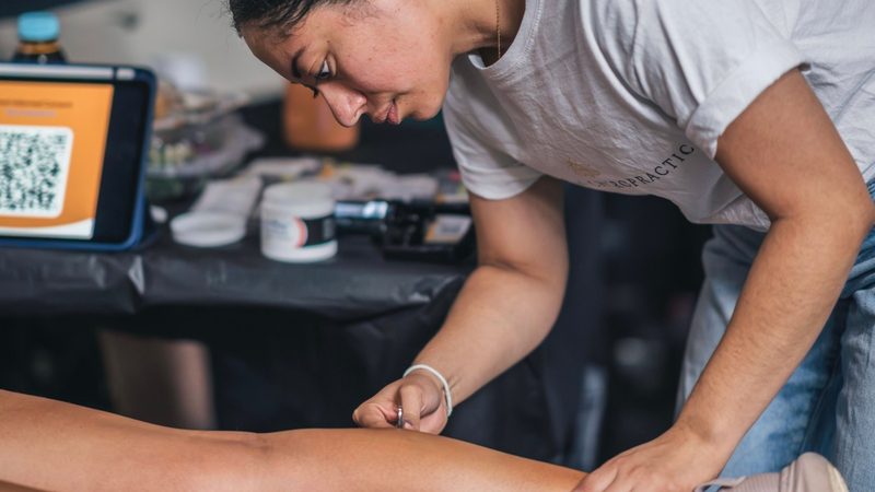 Dr. Stef Cruz-Kostrova adjusting a patient at Firefly Chiropractic